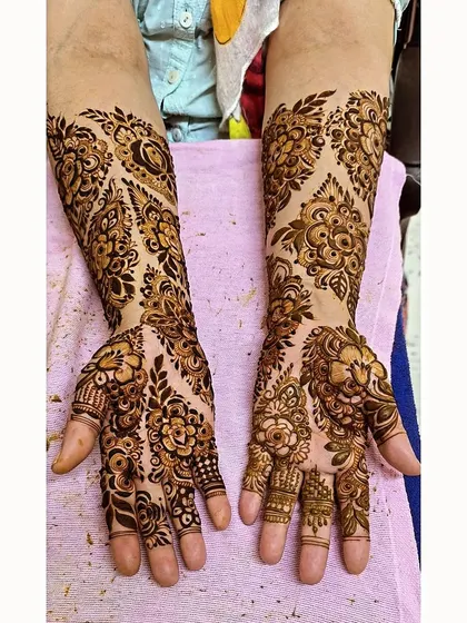 A beautiful example of asymmetrical floral design, where each hand has a unique but complementary pattern.