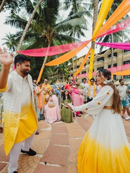 Making an entrance with a bang! The couple's entry was a high-energy affair with colorful smoke bombs and the infectious beats of dhol players, setting the tone for a fun-filled Haldi.