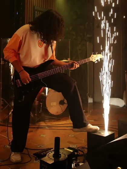 Our bassist setting off stage pyrotechnics with his foot while grooving. We love adding that extra spark to our shows.