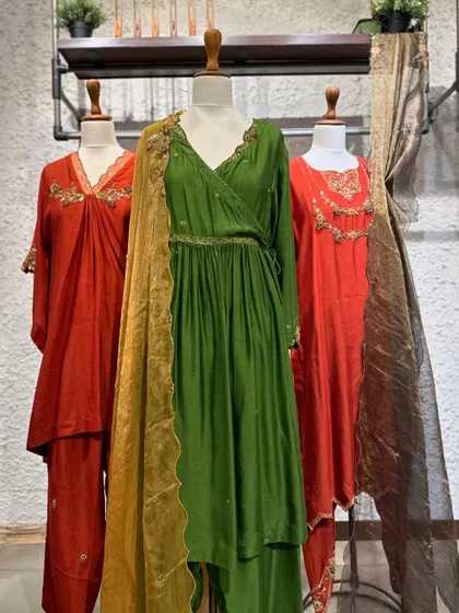 A collection of suits in earthy tones of rust and olive green. These colors are a sophisticated alternative to brighter hues and are perfect for autumn festivities.