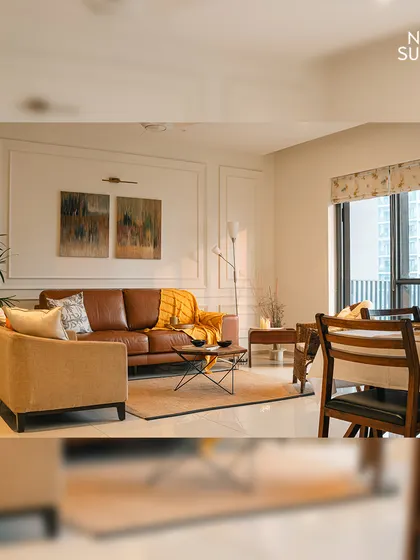 This wider view shows the open-plan living and dining area, designed to be light and airy. The large window allows for plenty of natural light, enhancing the feeling of spaciousness.