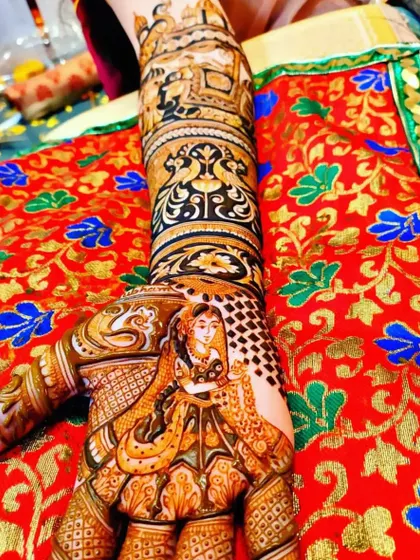 A close-up of a bride's hand, showcasing a detailed portrait of a bride in her doli, a classic and emotional part of the wedding story.