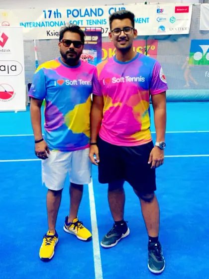 Standing with one of my senior players at the Poland Cup. The bond between a coach and player is crucial for success in high-pressure tournaments.
