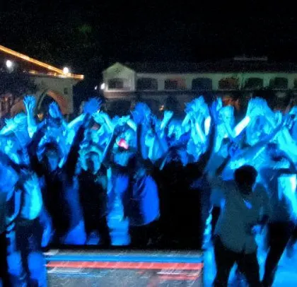 The crowd with their hands up, enjoying the music under the blue lights. It was a night of pure energy and good vibes.