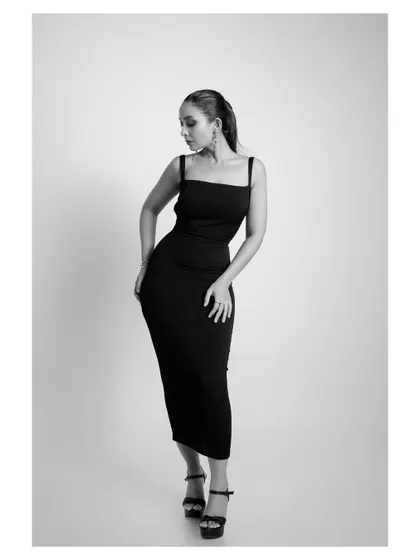 A classic black and white fashion portrait. The elegant dress and pose create a timeless image that would be at home in any high-fashion magazine.