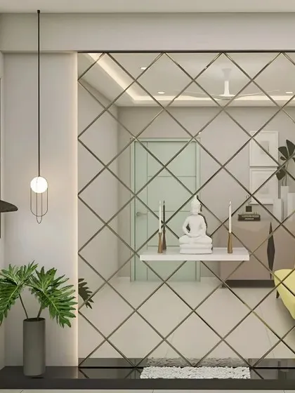 This design uses a large, diamond-patterned mirror wall to make the entryway feel spacious and bright. A simple floating shelf in front of the mirror holds a white Buddha statue, creating an illusion of it floating in a serene, reflective space.