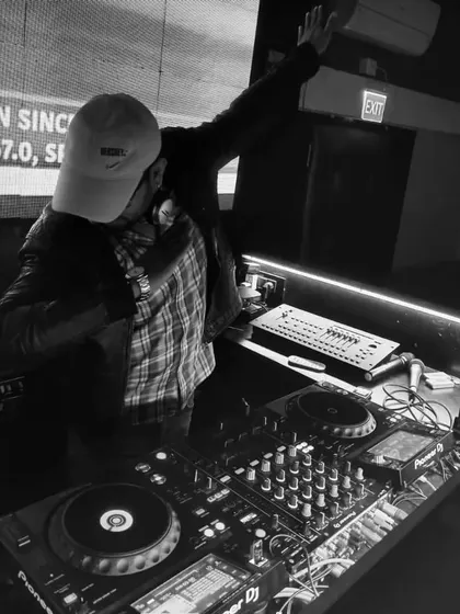 A black and white shot of me raising a hand in celebration, perfectly timed with the action on the screen behind me.