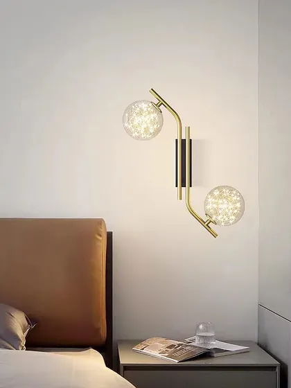 A beautiful wall sconce with two starry, textured globes. This fixture adds a touch of magic and elegance to this bedside.