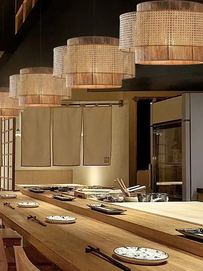 Our drum-shaped rattan pendant lights are a popular choice for restaurants and cafes seeking a modern yet natural aesthetic. Hung in a series over a long table, they provide focused light while adding a strong decorative element to the interior design.