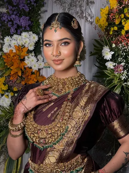 Another beautiful portrait of the bride, showcasing the rich color of the saree and the intricate workmanship of the jewellery.