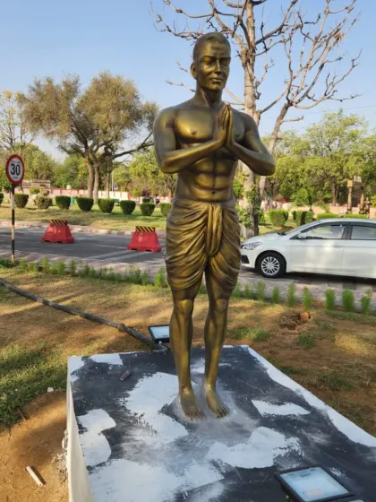 The 'Pranamasana' (Prayer Pose) statue from the Surya Namaskar collection, standing ready for installation.