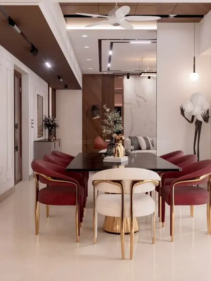 A long shot of the dining area, showing its connection to the living room. The bold red dining chairs add a pop of color, creating a distinct yet harmonious zone within the larger open-plan space.