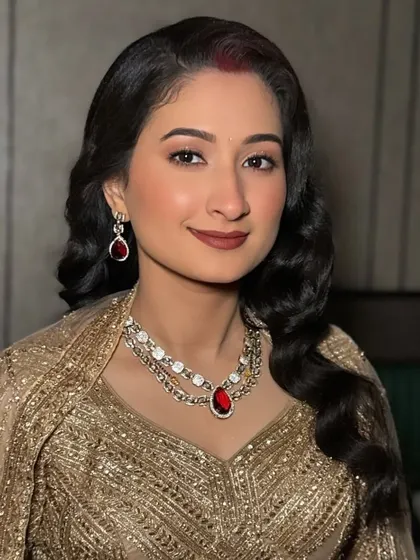 A smiling portrait of our reception bride. Her radiant skin and elegant makeup ensure she looks stunning and feels confident throughout her evening celebration.