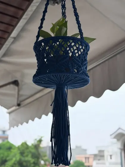 This multipurpose basket in a deep navy blue can be used as a hanging planter or for storage. It adds a unique touch to your balcony decor.