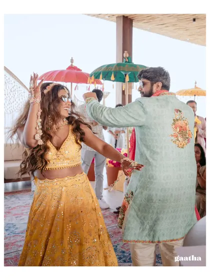 The bride and groom share a dance at their Bali Haldi, showcasing the fun and energy we infuse into our destination weddings.