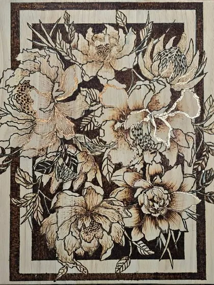 In this pyrography piece, I combined wood burning with gold foiling to create a beautiful floral design. The gold adds a touch of light and elegance to the rustic feel of the burned wood.