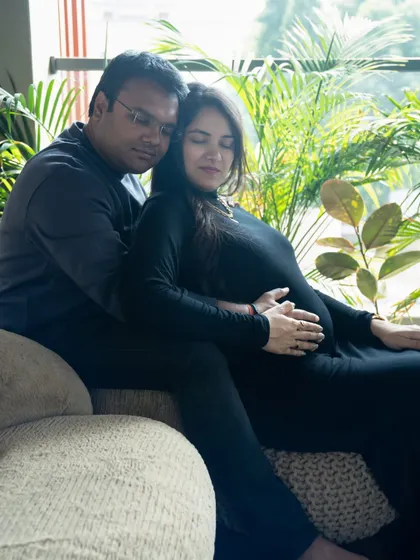 A peaceful moment at home. This photo captures the quiet anticipation of waiting for the baby, with the couple relaxing together in a natural setting.
