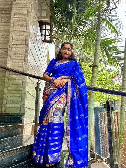 Our client looking absolutely regal in her royal blue pure Mysore crepe saree with a digital print.