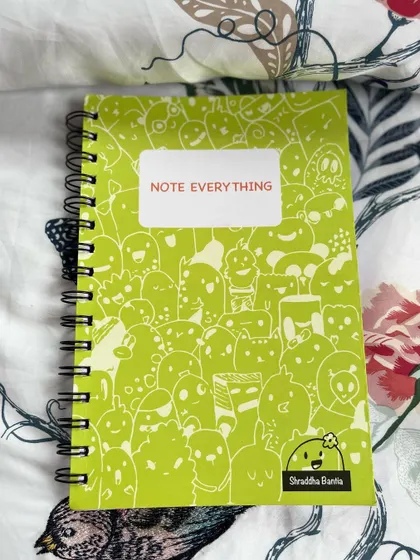 The lime green A5 notebook, covered in a fun pattern of my signature doodles.