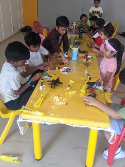 A busy table of young engineers and artists working together on their fighter jet models. Our workshops encourage collaboration and peer learning in a fun setting.