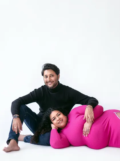 A cozy and intimate pose, showing a different side of the modern pink and black theme. It’s a quiet moment of rest and connection.