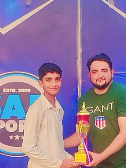 Presenting an award at a youth cricket tournament. Recognizing talent is a key part of all my sporting events.