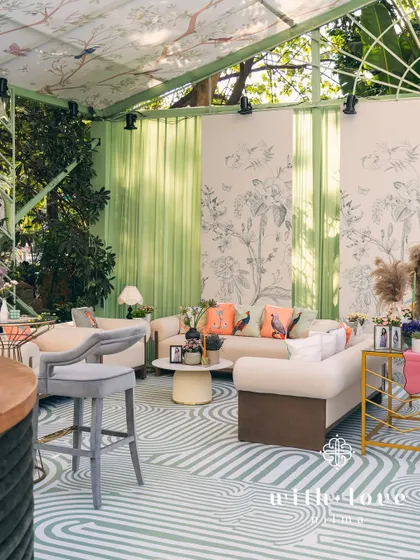 A serene and modern baby shower designed as a chic conservatory. Featuring custom botanical print walls, sage green accents, and contemporary furniture, this setup creates a light-filled, elegant space for celebration.