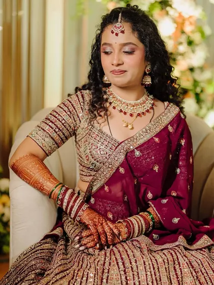 A serene and elegant pose. The makeup is soft and romantic, with a focus on her beautiful eyes and glowing skin.