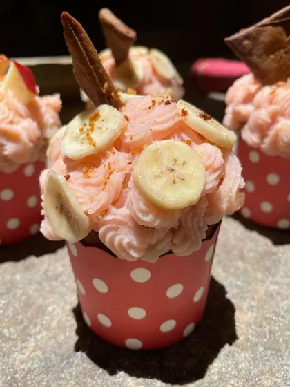This pupcake is topped with fresh banana slices and a homemade biscuit for a bit of crunch.