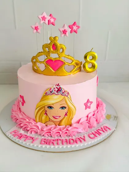 This Barbie cake is fit for a princess, with a big golden tiara and pink ruffle details.