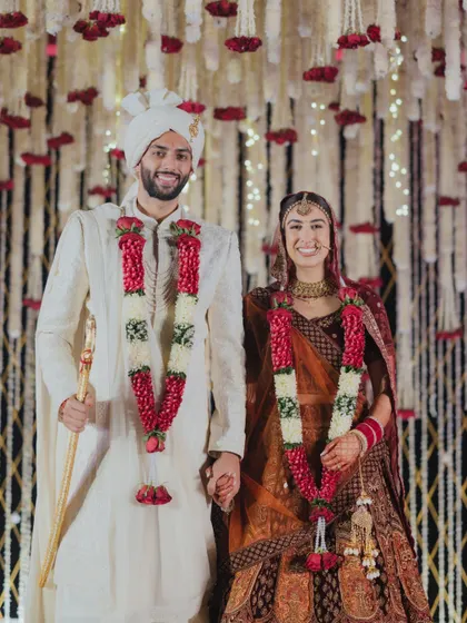 A classic portrait of the newlyweds. The intricate floral backdrop, composed of thousands of tuberoses, was designed to create a sense of grandeur and texture for their wedding photos.