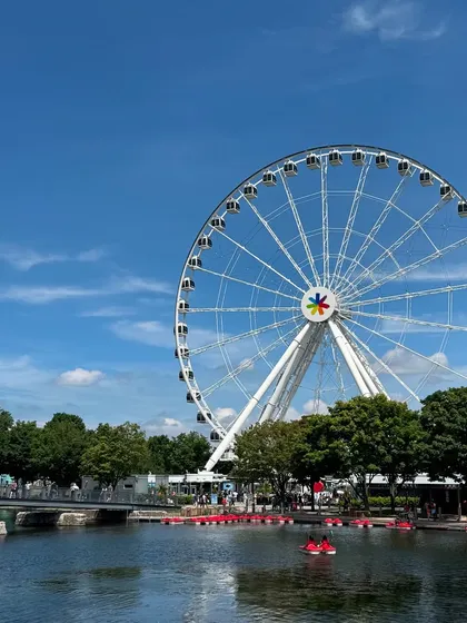 The iconic La Grande Roue de Montréal against a perfect blue sky at the Old Port.