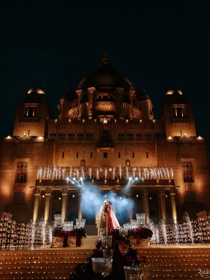 The grand finale of the wedding ceremony against the illuminated Umaid Bhawan Palace, a breathtaking image featured in ELLE India.
