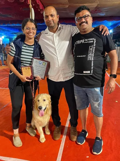 A happy family with their winning Golden Retriever.