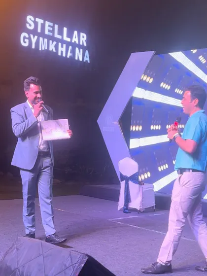 On stage at the Stellar Gymkhana for a Bureau Veritas family day event. Engaging with audience members directly is a key part of my corporate mentalism act.
