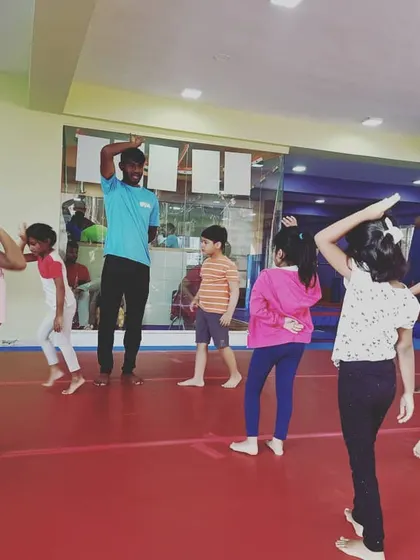 Our "Good Friends" class participating in the "Number Tumblers" theme. These images show the group learning advanced math and tumbling skills through warm-ups, stretches, and games.