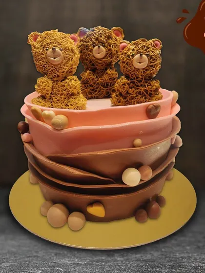 This charming cake is perfect for a teddy bear lover. It features intricate piped teddy bears on top of a chocolate-wrapped cake, combining cute design with delicious flavors.