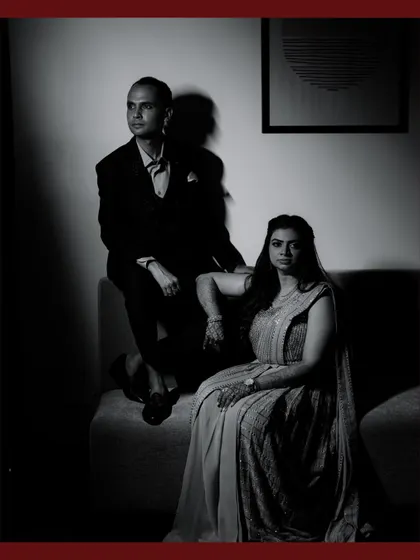 A dramatic, high-contrast black and white portrait of a couple, showcasing a more formal and stylized approach to wedding photography.