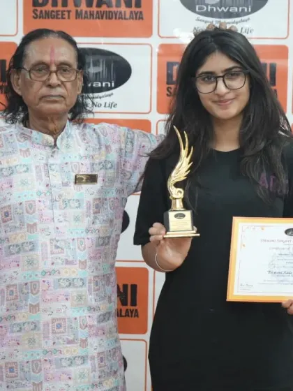 A senior guru with his student, celebrating her success.