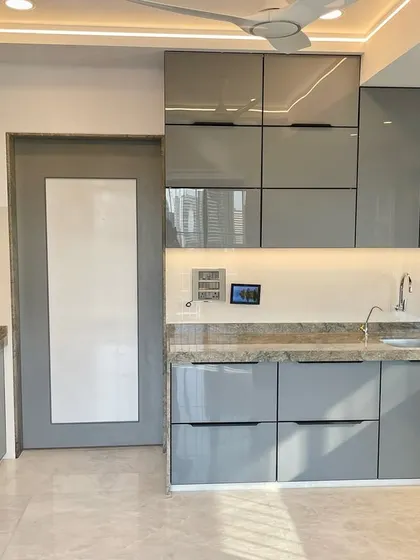 A full view of the C-shaped kitchen in Monoton English Grey, showcasing the harmonious and modern design.