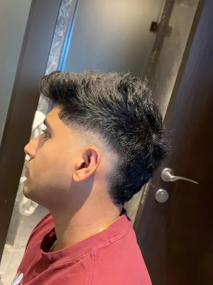 A profile shot of Yash Thakur's modern mullet.