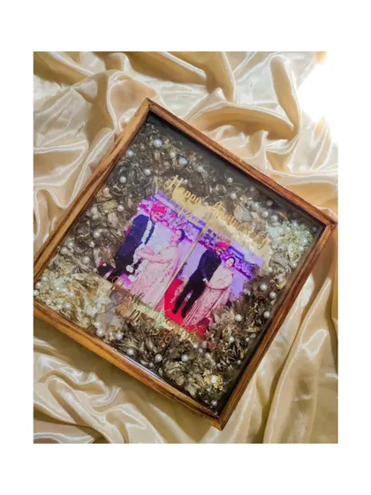 Another angle of the parents' anniversary frame, showing the depth of the preserved flowers and the loving details included to celebrate their special milestone.