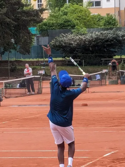 Nithin practicing his serve on a European clay court. This experience will be invaluable for his growth as a competitive player.
