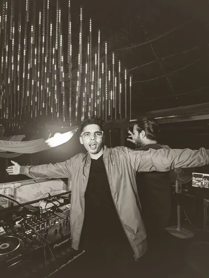 A classic black and white shot, arms open wide, embracing the new year and the crowd.