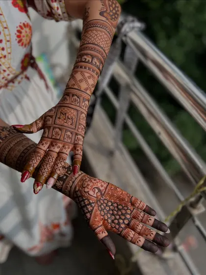 A different angle of the back-of-hand design, showing the peacock and elephant details.