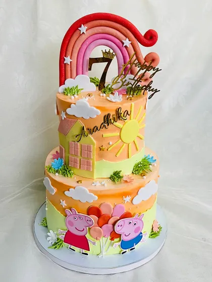 A two-tier Peppa Pig cake with a warm, sunset-orange color palette. This design features Peppa and George with balloons under a big rainbow, ready for a party.