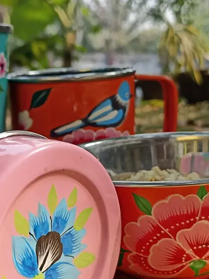 A collection of vibrant, hand-painted steel cups and bowls, bringing a splash of colour and art to everyday items.