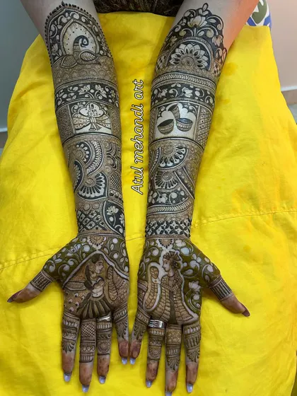 A beautiful portrait mehandi showing the bride and groom in a loving embrace, surrounded by traditional wedding elements.