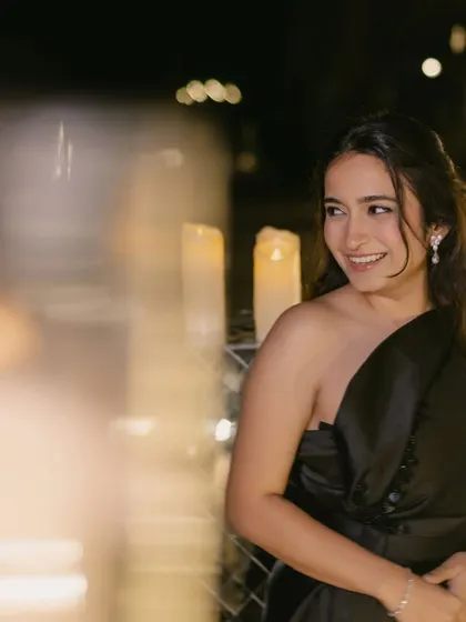 A candid moment of joy at a cocktail party. The soft glam makeup and simple, elegant hairstyle let her natural beauty shine through.