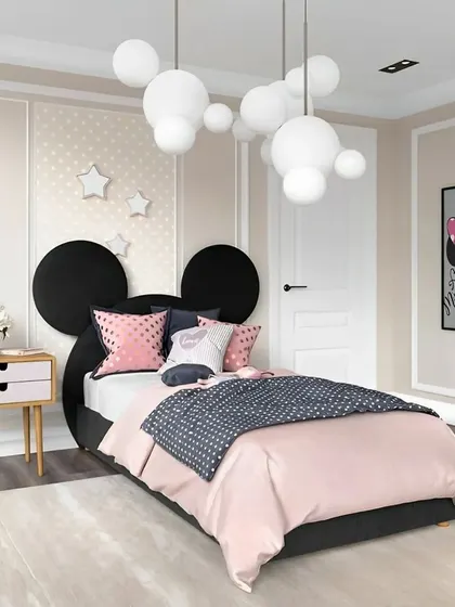 A charming Minnie Mouse-themed bedroom for a little girl. The iconic silhouette headboard and bubble-like pendant lights create a playful and dreamy atmosphere.